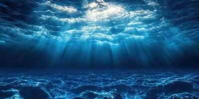 Beautiful underwater view with sunlight streaming through the ocean surface and illuminating the water photo