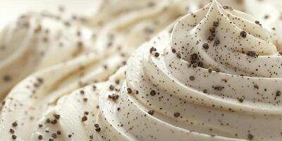 Creamy vanilla frosting topped with specks of black pepper adds a unique twist to desserts photo