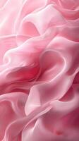 Soft pink silk fabric draping elegantly with delicate waves and flowing textures in a creative display of texture and color photo
