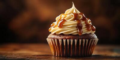 Delightful caramel cupcake topped with creamy frosting captured in warm lighting photo
