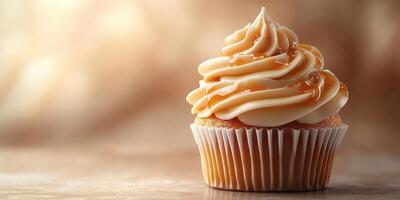 Cupcake with creamy frosting and drizzle on a textured surface in warm lighting photo