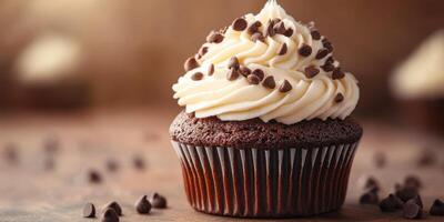 Rich chocolate cupcake topped with smooth vanilla frosting and chocolate chips on a rustic wooden background photo