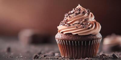 Indulging in a delicious chocolate cupcake topped with creamy frosting and chocolate shavings photo
