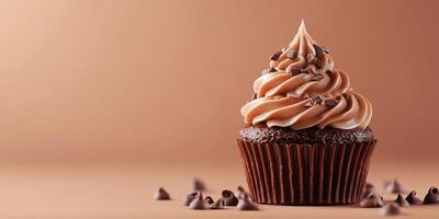 Delightful chocolate cupcake adorned with creamy frosting and chocolate chips against a warm background photo