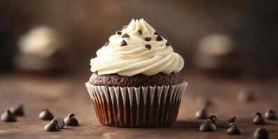 Delicious chocolate cupcake topped with creamy frosting and chocolate chips on a rustic wooden table photo