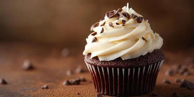 Delightful chocolate cupcake topped with creamy frosting and chocolate shavings on a rustic wooden background photo