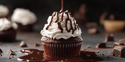 Chocolate cupcake with whipped cream and chocolate drizzle surrounded by ingredients in a dark kitchen setting photo