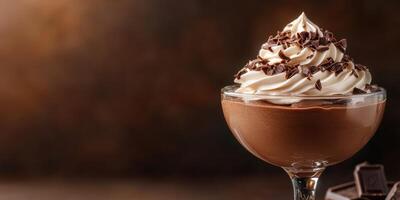 Delicious chocolate mousse topped with whipped cream and chocolate shavings photo