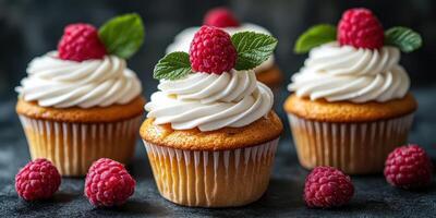 Raspberry topped cupcakes with whipped cream and mint leaves on a dark background, perfect for dessert lovers photo