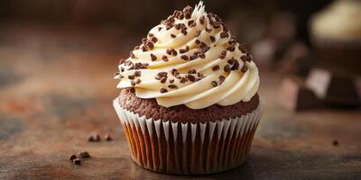 Delicious chocolate cupcake topped with creamy frosting and chocolate sprinkles on a rustic wooden surface photo
