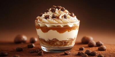 Delicious dessert with layers of cream, caramel, and chocolate garnished with cocoa photo