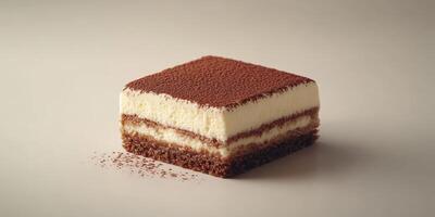 Delicious square tiramisu slice on a neutral background showcases creamy layers and cocoa dusting for dessert lovers photo