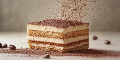 Delicious layers of creamy dessert with cocoa dusting on top served on a simple background photo