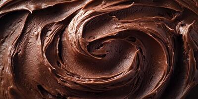 Creamy chocolate frosting swirled in a bowl ready for dessert decorating photo