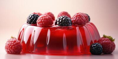 Delicious red gelatin dessert topped with fresh raspberries and blackberries on a light background photo