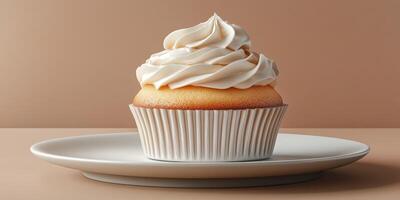 Deliciously frosted cupcake on a white plate against a minimalistic background photo