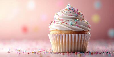 Delicious cupcake topped with creamy frosting and colorful sprinkles on a pink background photo