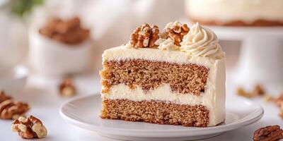 Deliciously moist walnut cake slice topped with creamy frosting and nuts on a white plate photo