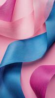 Vibrant colored ribbons on a soft pink background create a visually striking arrangement for creative projects and decorations photo