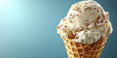 Creamy vanilla ice cream served in a waffle cone with a sprinkle of nuts under soft blue lighting photo