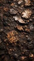 Textured surface of layered soil with various shades of brown and hints of gray observed in a natural environment photo