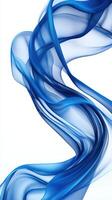 Flowing blue fabric creates elegant waves and soft textures against a white background, highlighting its graceful movement and lightness photo