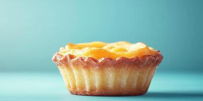 Freshly baked dessert tart with a golden crust and creamy filling on a blue background photo