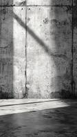 Concrete wall and floor bathed in light create a striking minimalist setting for artistic purposes photo