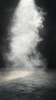 White smoke swirling on a dark background creates a mysterious atmosphere in an empty space photo