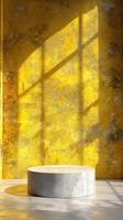 Bright yellow wall with shadows cast on a circular pedestal in a modern interior space photo