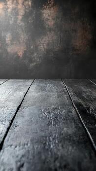 Dark textured wooden surface with soft lighting creating a moody atmosphere for artistic presentations or photography photo