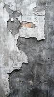 Cracked concrete wall with peeling texture revealing underlying layers in urban setting photo