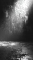 Mysterious light illuminating an empty space with textured walls and floor in monochrome tones at dusk photo