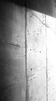 Light and shadow interplay on textured concrete wall showcasing industrial design aesthetic in urban environment photo