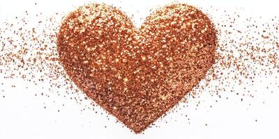 Heart shape made of shimmering copper glitter on white background for decorations and events photo