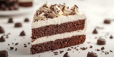 Delicious chocolate cake slice with creamy frosting and chocolate shavings on a light surface during a dessert gathering photo