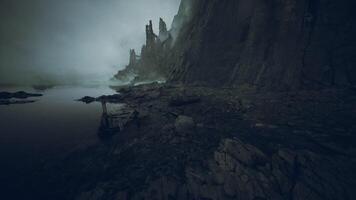 Ruined cliffs by a misty coastal area at dawn with a mysterious atmosphere video