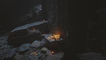 Candlelit ruins create an eerie atmosphere at dusk in an ancient site video