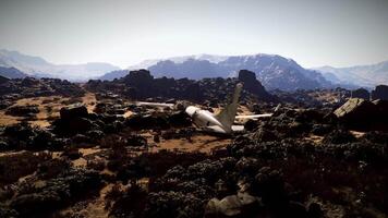 Plane crash site in rocky mountainous terrain during daytime video