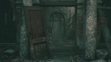 Abandoned building with broken door and shadows in overgrown courtyard video