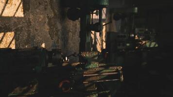 Light streaming through windows in an industrial workshop during the evening video