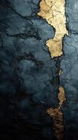 Cracked black wall with gold accents creating a striking visual contrast and texture photo