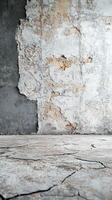 Close-up view of cracked concrete floor and textured wall in an abandoned building during daylight hours photo
