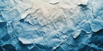 Crumpled blue paper texture with light and shadows creating an abstract background effect photo