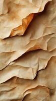 Crumpled brown paper texture showing intricate wrinkles and shadows in a warm, natural light photo