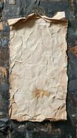 Crumpled old paper resting on a textured dark surface revealing signs of wear and age in a vintage setting photo