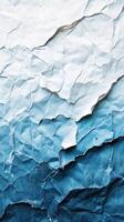 Textured layers of crumpled paper showcasing a gradient from light to dark blue, creating an artistic backdrop for design photo