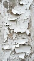 Cracked and peeling white paint on an aged wall reveals weathered texture and history in urban setting photo