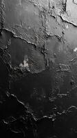 Textured black wall surface with layers of peeling paint captures an industrial aesthetic and raw beauty in modern interior design photo
