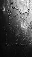 Textured dark wall surface showcasing peeling paint and cracks in a dimly lit environment photo